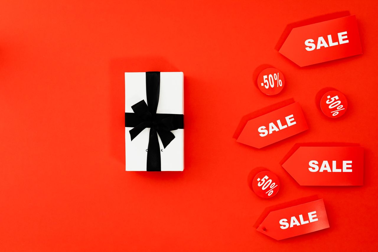 our-mission Bright red sale tags and gift box against a vivid background, perfect for promotions.